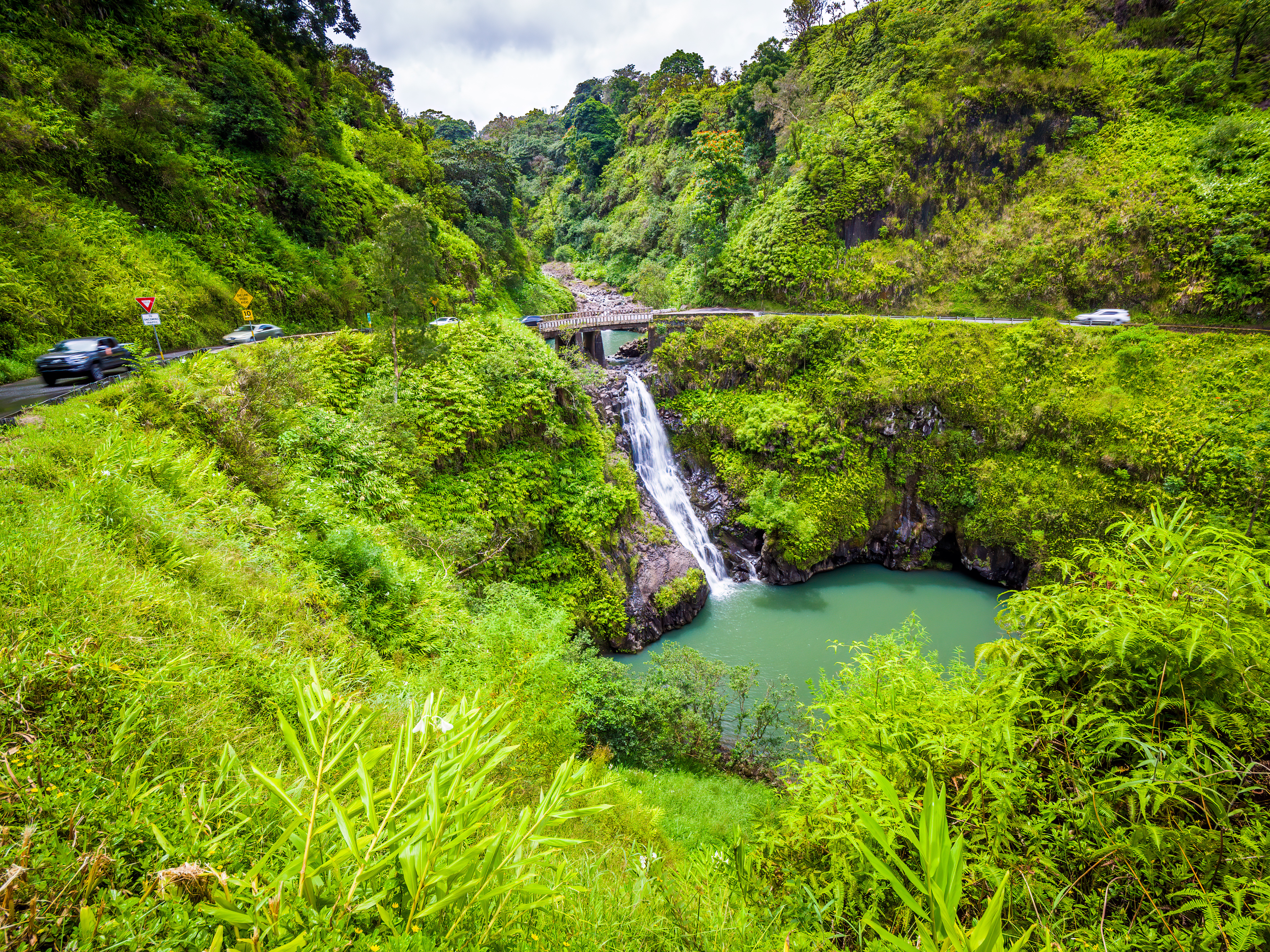 Maui, Hawaii Hana Highway - Wailua Iki Falls (Wailuaiki). Road to Hana connects Kahului to the town of Hana Over 59 bridges, 620 curves, tropical rainforest